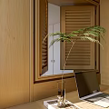 Fern Plant in Glass Vase on Windowsill with Wooden Blinds and Laptop Nearby