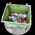 Green Trash Bin With Wheels Filled With Plastic Bottles And Waste On Ground