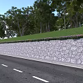 Roadside Stone Wall With Grass And Flowers On Top Surrounded By Trees