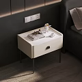 Modern White Bedside Table With Metal Legs And Decorative Items In Bedroom