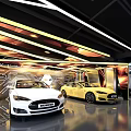 Modern 4S Car Dealership Showroom Featuring Displayed White And Yellow Vehicles With Modern Lighting