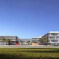 Modern Industrial Factory Building Exterior With Glass Curtain Walls And Green Lawn