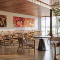 Cozy Restaurant Interior With Wooden Beams Rattan Pendant Lights Natural Light And Art Paintings