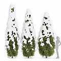 Three Topiary Trees With White Decorative Trim And Green Foliage In Garden