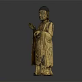 Golden Standing Buddha Statue With Robed Figure And Raised Hand Gesture In Traditional Decorative Design
