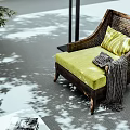 Woven Rattan Lounge Chair with Green Cushion Striped Pillow and Plaid Blanket in Shadowy Light