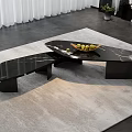 Modern Black Marble Coffee Table with Irregular Shape on Gray Rug and Fruit Bowl