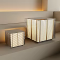 Modern Geometric Table Lamps With Striped Shade And Warm Light On Minimalist Steps