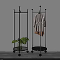 Modern Clothes Rack With Wheels Hanging Clothes And Green Plant For Home Use