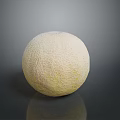 Fresh Cantaloupe With Textured Light Yellow Skin On Dark Reflective Surface