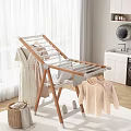 Foldable Wooden And Metal Clothes Drying Rack With Hanging Clothes In Bright Laundry Room