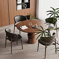 Modern Dining Area With Round Wooden Table Black Chairs And Green Plants
