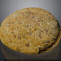Fresh Round Multigrain Bread Loaf Topped With Sesame Flax And Sunflower Seeds