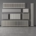 Various Styles of Modern Radiators Displayed on Gray Wall and Floor Surface