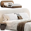 Double Bed with Upholstered Headboard White Pillows Brown Cushion Light Colored Quilt and Bedside Table