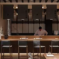 Traditional Japanese Restaurant Featuring Chef At Wooden Counter With Gray Chairs And Decorative Screens