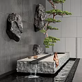 Modern Water Fountain with Hanging Rocks Potted Pine Tree Gray Wall Stone Platform and Water Flow