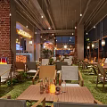 JOHOBUS Bar Interior With Green Plants Tables And Liquor Displays
