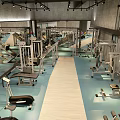 Spacious Modern Fitness Gym Interior With Treadmills Workout Benches Colored Exercise Balls And Concrete Walls