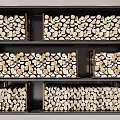 Neatly Arranged Stone Wood Split Logs In Wooden Crates On Black Shelves