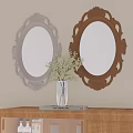 Two Oval Mirrors with Silver Gold Carved Frames Above Wooden Shelf with Vase Green Plants