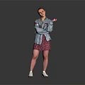 A Woman In Gray Jacket And Pink Floral Skirt Standing On Dark Background With White Sneakers