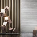 Geometric Cube Sculpture With Metallic Finish In Modern Interior Space With Vertical Striped Wall