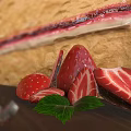 Strawberry Cream Cake with Sponge Layers Decorated with Fresh Strawberries on Wooden Tray and Fork