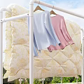 White Clothes Drying Rack With Quilt And Light Blue Pink Clothes On Balcony