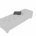 Light Colored Tufted Bench with Round Legs and a Book on Top 3d model