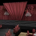 Elegant Wedding Stage Setup With Red Curtains Floral Arrangements And Chandeliers