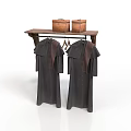 Dark Colored Clothes With Brown Decorations Hanging On Wooden Shelf With Baskets