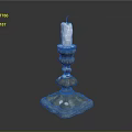Decorative Metallic Candle Holder With White Candle And Ornate Base Design