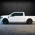 White Modern Pickup Truck With Crew Cab And Black Wheels In Indoor Setting