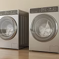 Two Modern Silver Front Loading Washing Machines With Control Panels On Wooden Floor
