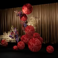 Elegant Floral Installation With Red Spherical Blooms Golden Frames And Woman In White Gown