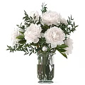 White Peony Flowers Arrangement In Transparent Glass Vase With Fresh Green Leaves And Clear Water