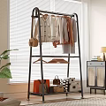 Clothing Rack With Hanging Clothes Bags Storage Boxes Near Plant And Window Blinds