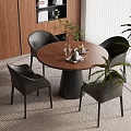 Modern Dining Area With Round Table Black Chairs Green Plant And Area Rug