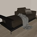 Light Grey Two-Seater Sofa With Dark Brown Pillow And Grey Blanket On Wooden Floor