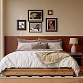 Double Bed with Wooden Headboard Soft Pillows Beige Blanket Decorative Paintings Near Nightstand White Lamp