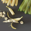 Fresh Yellow Bananas Peeled Sliced in Bowl and Mesh Bag with Green Bananas