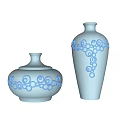 Light Blue Ceramic Vessels with Spiral Patterns Lidded Jar and Tall Vase on White Background