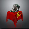 White and Green Helmet with Transparent Visor on Red Tablecloth with Yellow Hammer Sickle Symbol