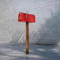 Red Commercial Mailbox with U.S. MAIL Sign on Wooden Post Against Gray Brick Wall