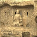 Ancient Garden Landscape Featuring Stone Buddha Statue And Carved Reliefs