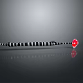 Black and White Striped Elongated Object With Red Arrow Tip on Gray Background and Reflection