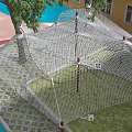 Kindergarten Outdoor Play Area With Net Climbing Structure Tree And Colorful Ground