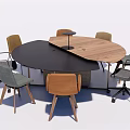 Round Conference Table With Mixed Black And Wooden Surface And Various Office Chairs