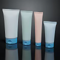 Pastel Colored Cosmetic Tube Containers With Blue Base Caps On Black Reflective Background
